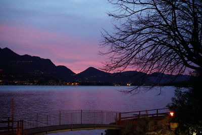 Scenic view of lake against sky at sunset