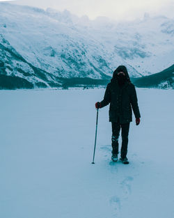 Man standing on snow covered land