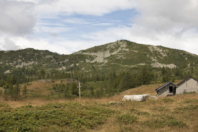 Scenic view of field and mountains against sky