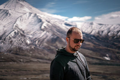 Portrait of young man standing on mountain