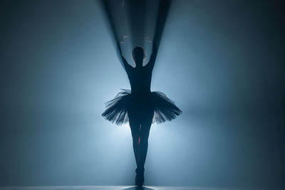 Silhouette ballet dancer dancing on stage