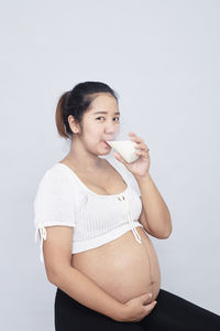 Portrait of a beautiful young woman over white background