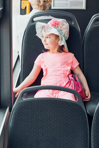 High angle view of girl sitting in car