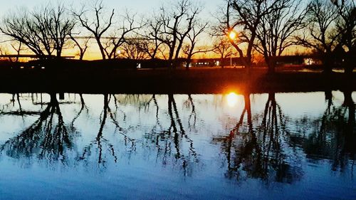 Scenic view of lake against sky at sunset