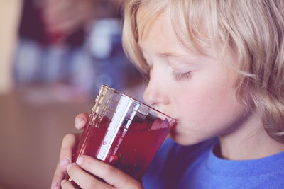 Close-up of boy sipping drink