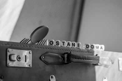 Close-up of spoon and forks with text over suitcase