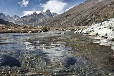 View of valley and mountain peaks against sky