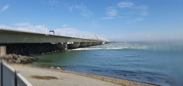Bridge over sea against sky