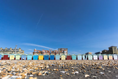 Surface level of beach huts against sky