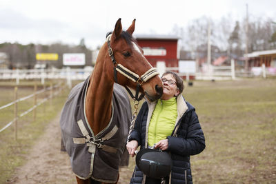 Smiling woman with horse