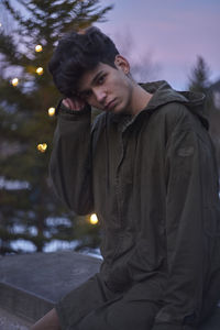 Man against christmas tree during sunset