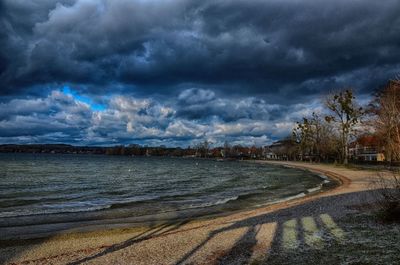 Scenic view of storm clouds over trees against sky