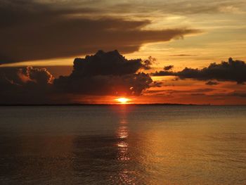 Scenic view of sea against romantic sky at sunset