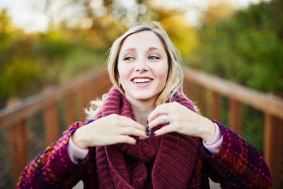 Portrait of smiling young woman in park