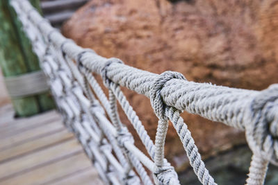 Close-up of rope tied on railing