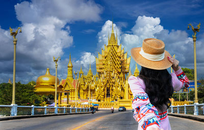 Rear view of woman standing against sky
