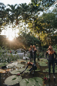 People enjoying on plants against trees