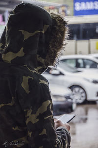 Side view of man driving car in winter