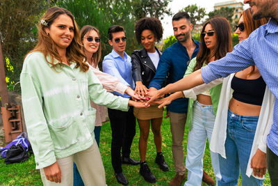 Group of diverse hands together joining concept , people joined hands as a team , stack of hands 