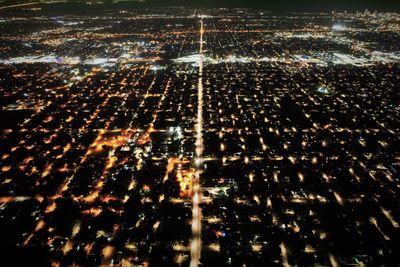 Aerial view of illuminated city at night