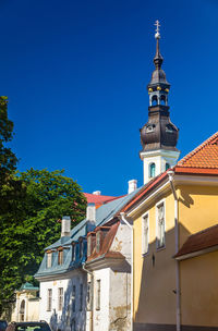 Low angle view of buildings against clear blue sky