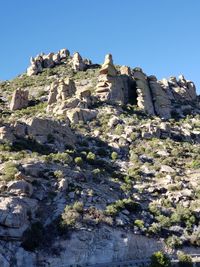 Low angle view of rock formation against clear sky