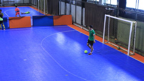 Man playing with ball on umbrella