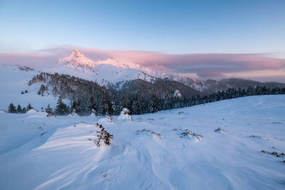 Scenic view of snow mountains against sky during sunset