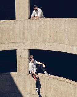 Full length of man standing on concrete wall