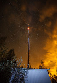 Low angle view of lighthouse against sky at night