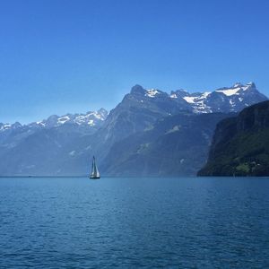 Scenic view of snowcapped mountains against blue sky