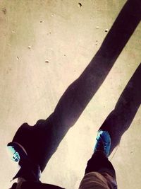 Low section of woman standing on tiled floor