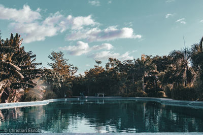 View of swimming pool in lake against cloudy sky