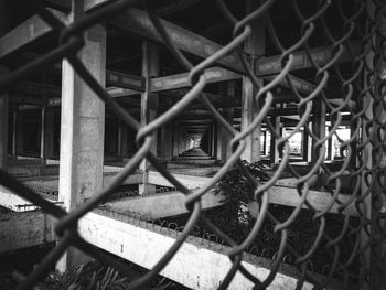 Full frame shot of chainlink fence against abandoned buildings