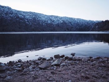 Scenic view of lake against sky during winter