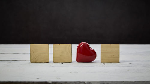 Close-up of red toy on table against black background