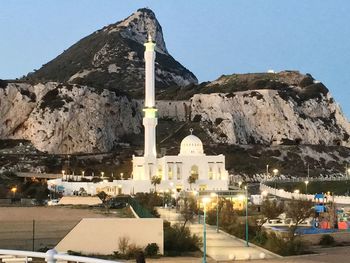 Cross against mountain range against clear sky