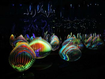 Close-up of bubbles against illuminated lights