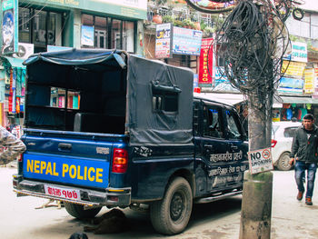Vehicles on road against buildings in city