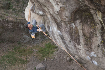 One man holding a rope while rock climbing in jilotepec, mexico