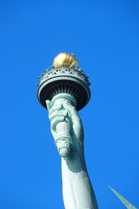 Low angle view of statue against blue sky