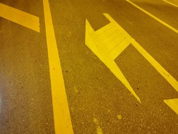 High angle view of arrow sign on road