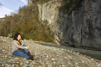 Woman sitting on rock