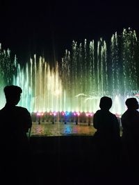 Rear view of silhouette people at fountain