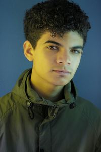 Portrait of young man against blue background