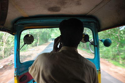 Rear view of man traveling in car