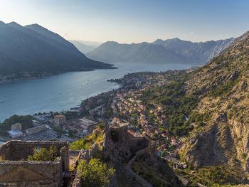 High angle view of sea and mountains against sky