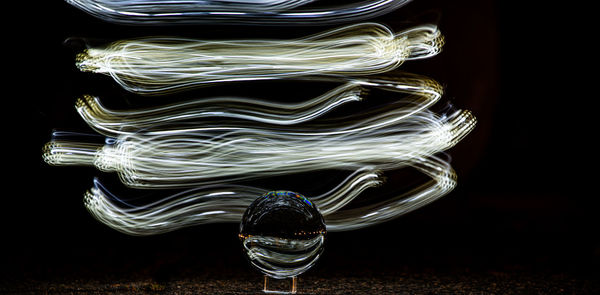 Close-up of light painting against black background