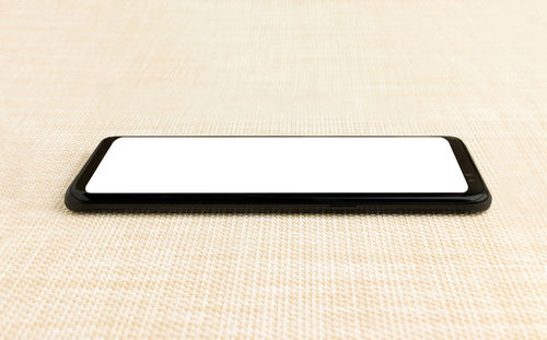 Close-up of smart phone on white background