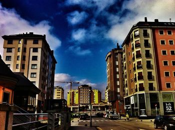 City street by buildings against sky